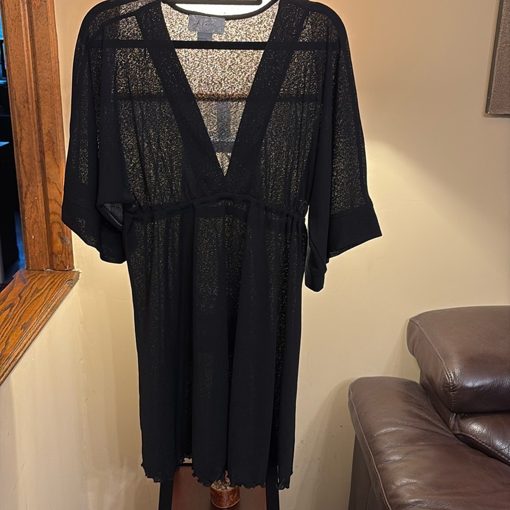 Never wore. Just in closet taking up space. Swim cover up.